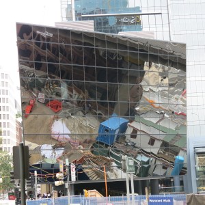 Reflection of construction project in wall of building next door.